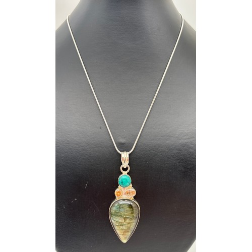 1032 - A semi precious stone set silver pendant, on an 18