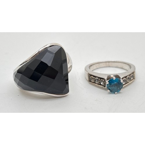1034 - 2 silver modern design rings. An organic shaped ring set with a piece of checkerboard cut black onyx... 