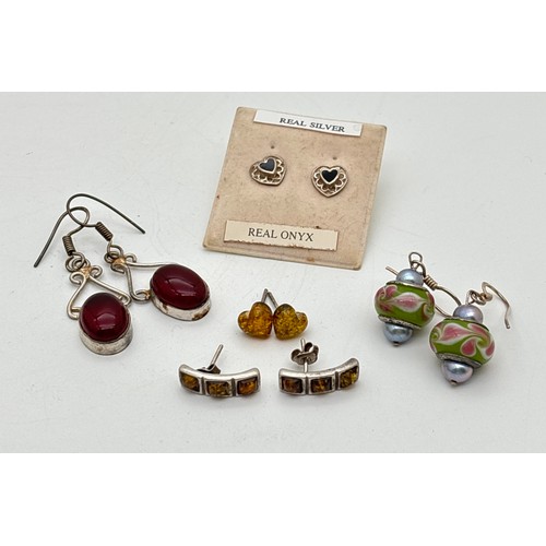 1035 - 5 pairs of silver stud and drop style earrings. To include honey amber set heart studs, red stone se... 