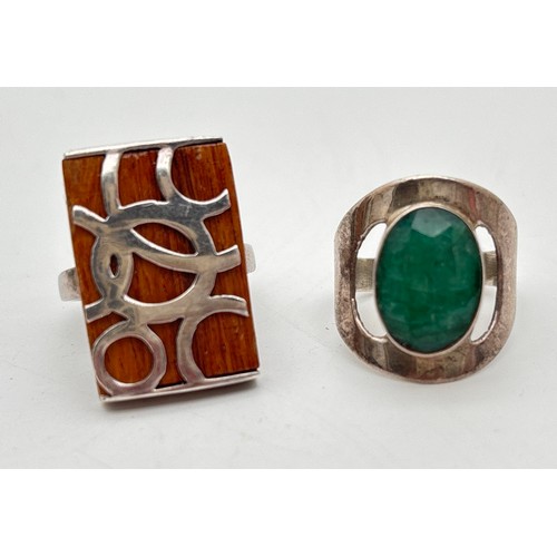 1039 - 2 contemporary design silver rings. A square wood set ring with abstract circular silver overlay, to... 