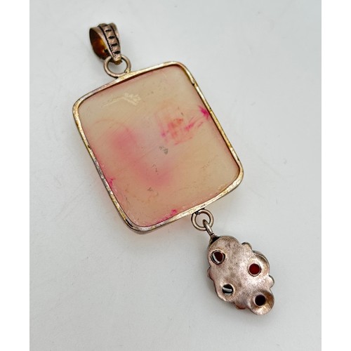 1041 - A large silver modern design pendant set with four round & oval cut garnets, suspended from a large ... 