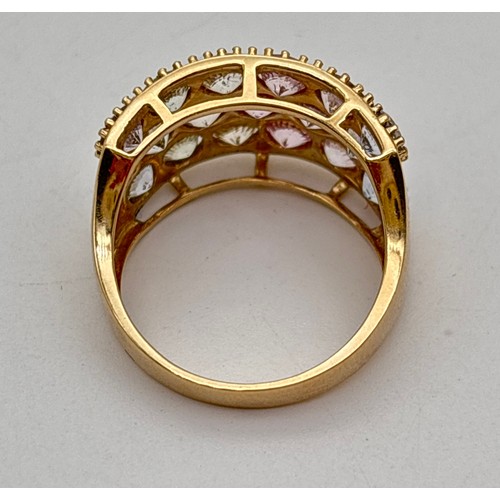 1001 - A 9ct gold wide band half eternity style ring set with a pastel rainbow spectrum of round cut spinel... 
