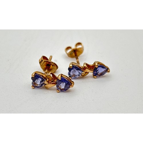 1007 - A pair of double heart tanzanite stone set stud style earrings, with butterfly backs. Approx. 1cm lo... 