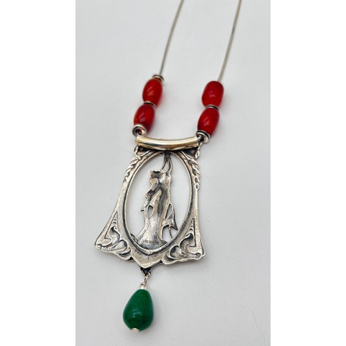 1013 - A silver Art Nouveau design necklace with large pendant modelled as a maiden with stylised floral de... 