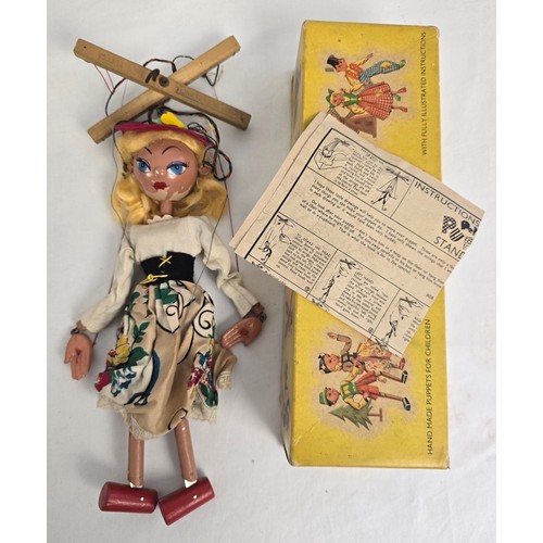 165 - A collection of vintage wooden toys together with a boxed 1950's Mitzi Pelham puppet. Wooden toys in... 
