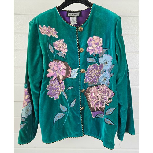A green velvet jacket with floral design throughout, by Indigo Moon (size M). Floral design in purple and blue with gold thread and glass bead detail. Jacket edged with black and gold piping and has bronze coloured buttons to front.