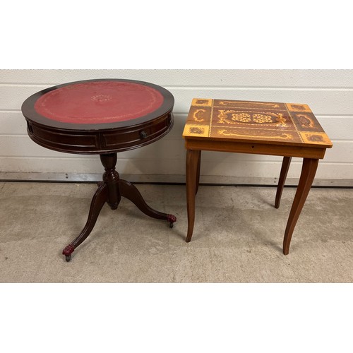 A vintage reproduction drum table on pedestal base with red leather ...