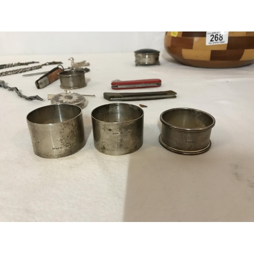 268 - WOODEN BOWL OF COLLECTABLES  IN A SILVER TRINKET BOX AND 4 SILVER NAPKIN RINGS