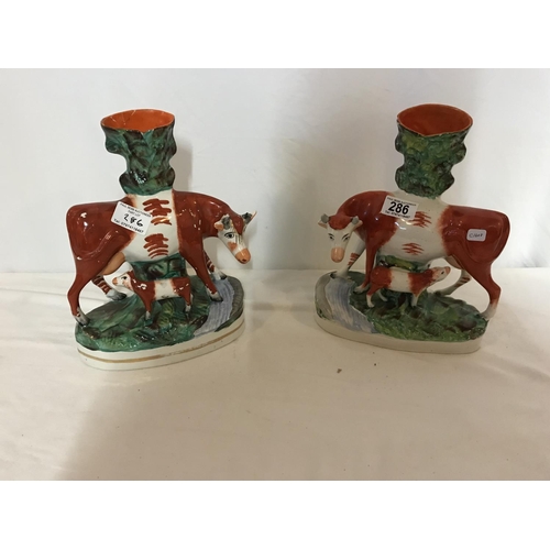 286 - PAIR OF STAFORDSHIRE COW SPILL VASES (1 A/F)