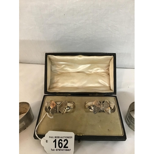 162 - PAIR OF HALLMARK SILVER CASED BUTTERFLY DECORATED NAPKIN RINGS AND 5 OTHER SILVER NAPKIN RINGS