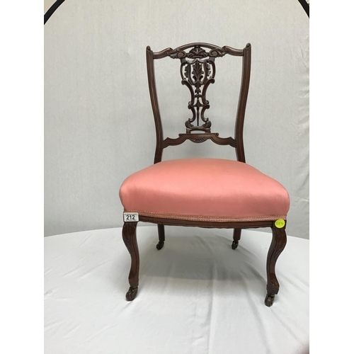 212 - VICTORIAN CARVED NURSING CHAIR ON BRASS AND CERAMIC CASTORS