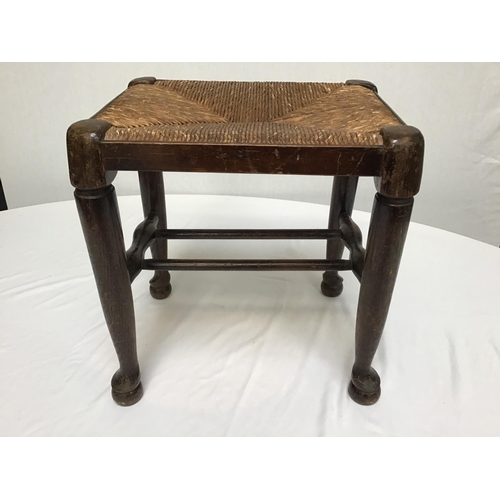 214 - OAK STRETCHERED LANCASHIRE FOOTSTOOL ON PAD FOOT