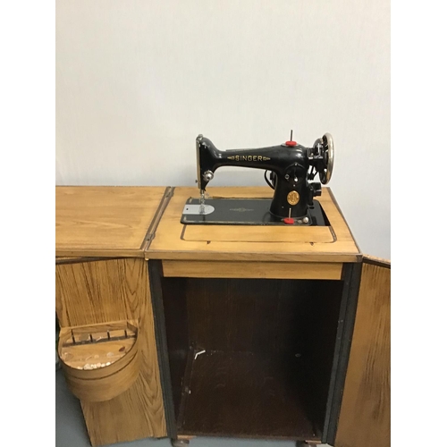 233 - SINGER ELECTRIC SEWING MACHINE IN CABINET