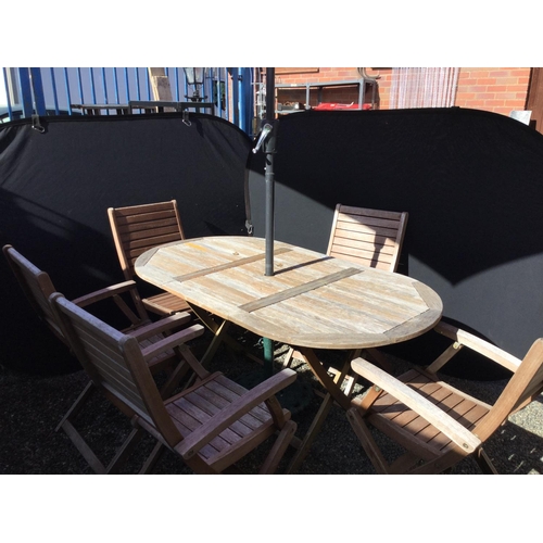 241 - GARDEN TABLE AND 6 CHAIRS AND GARDEN BROLLY WITH CAST IRON BASE
63 X 34