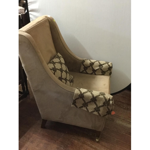 442 - EDWARDIAN UPHOLSTERED ARMCHAIR ON BRASS CASTORS