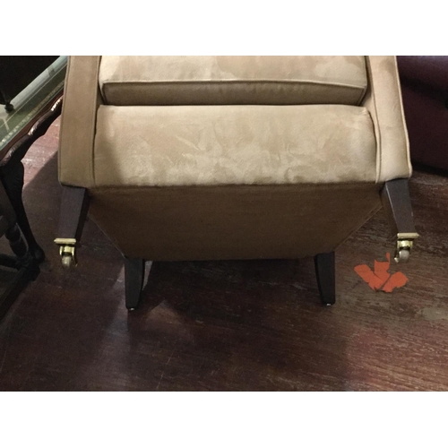 442 - EDWARDIAN UPHOLSTERED ARMCHAIR ON BRASS CASTORS