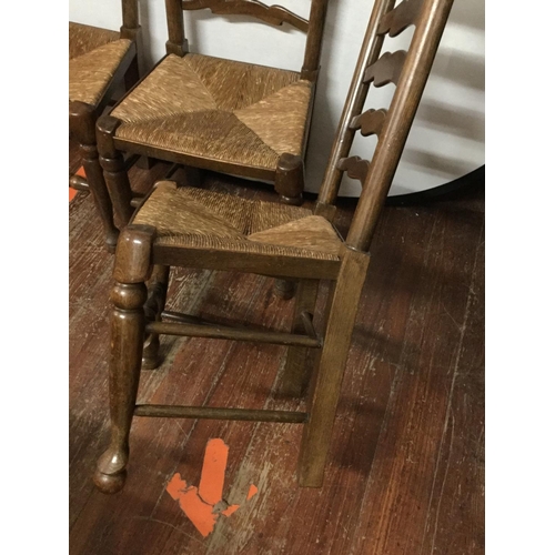 444 - 4 OAK STRETCHERED LADDER BACK DINING CHAIRS