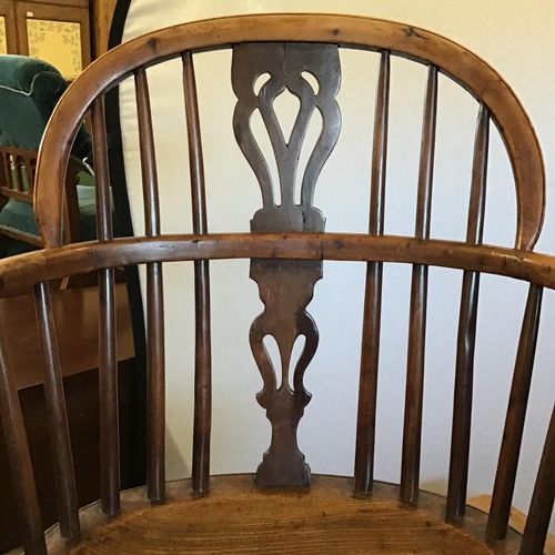 506 - EARLY OAK STRETCHERED FIDDLEBACK ARMCHAIR