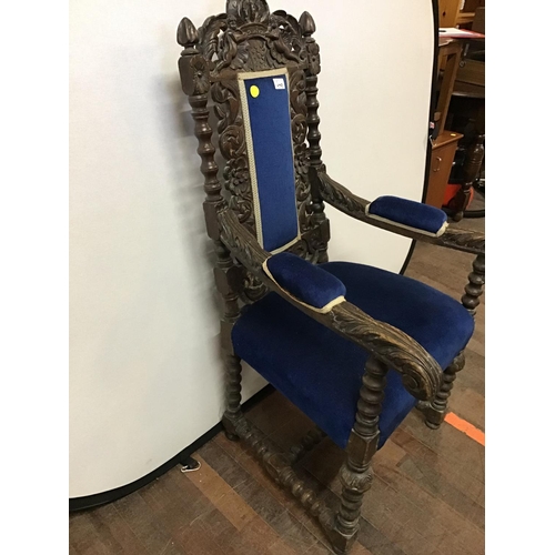 649 - HEAVILY CARVED OAK UPHOLSTERED ARMCHAIR