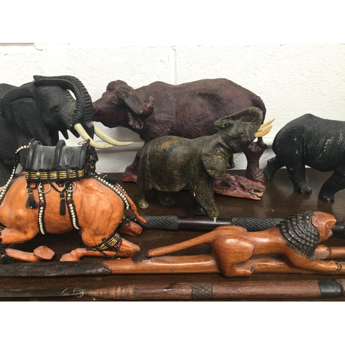 77 - QTY OF CARVED ANIMAL FIGURES, SPEARS, ETC