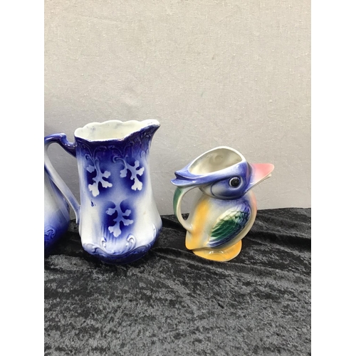 195 - 3 GRADUATED FLO BLUE JUGS AND BIRD JUG