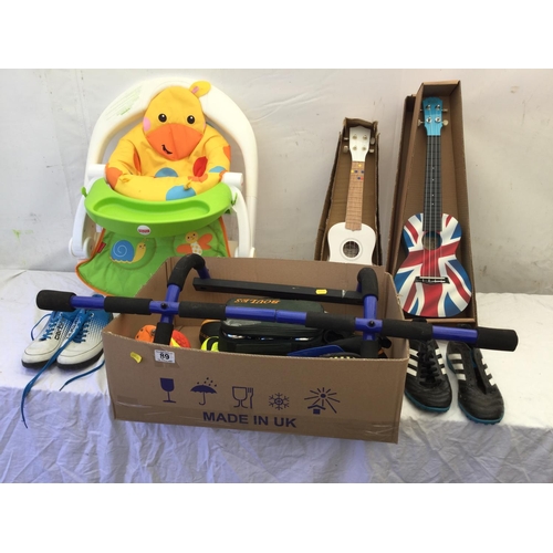 89 - BOX OF FOOTBALL BOOTS, TOY GUITARS, CHILDS SEAT AND BOULES