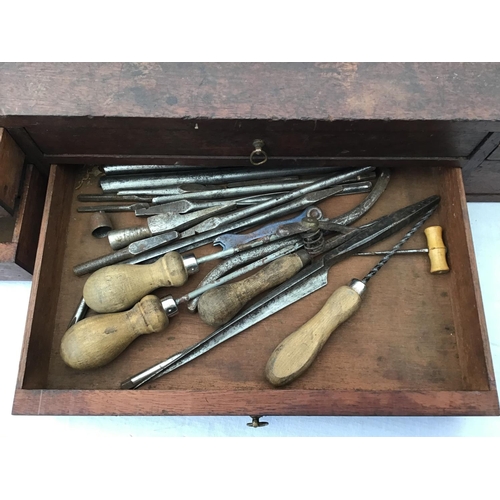 215 - LARGE VICTORIAN PINE TOOL BOX FITTED WITH BANKS OF DRAWERS COMPLETE WITH VICTORIAN TOOLS ETC