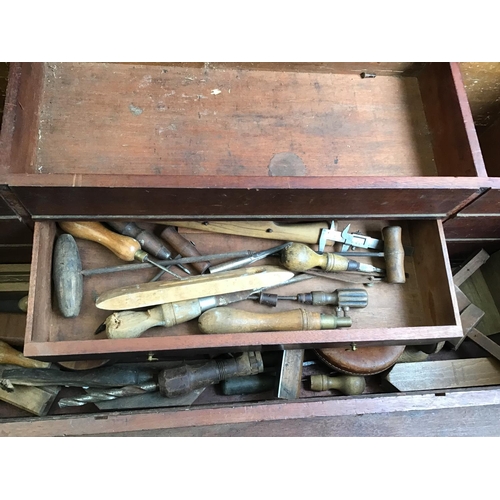 215 - LARGE VICTORIAN PINE TOOL BOX FITTED WITH BANKS OF DRAWERS COMPLETE WITH VICTORIAN TOOLS ETC