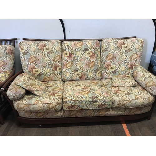 499 - FLORAL UPHOLSTERED ERCOL3 SEATER SETTEE CHAIR AND FOOTSTOOL  WITH GOLD BUTTON STAMP