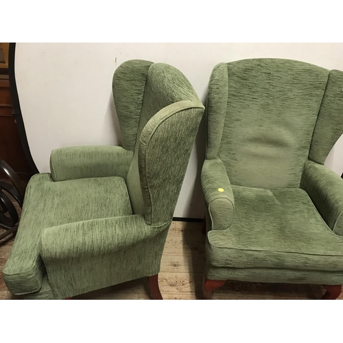 507 - 2 GREEN UPHOLSTERED WING BACK ARMCHAIRS  ON CABRIOLE LEGS