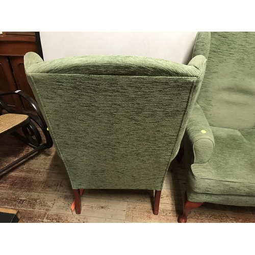 507 - 2 GREEN UPHOLSTERED WING BACK ARMCHAIRS  ON CABRIOLE LEGS