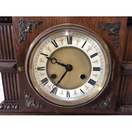 294 - EDWARDIAN OAK MANTLE CLOCK WITH KEY AND PENDULUM