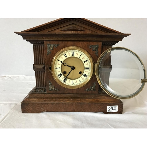 294 - EDWARDIAN OAK MANTLE CLOCK WITH KEY AND PENDULUM