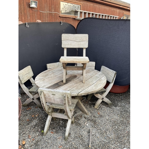 50 - LARGE OAK GARDEN TABLE WITH 6 HEAVY MATCHING WOODEN CHAIRS STAMPED ACORN HARDWOOD FURNITURE
DIA 55