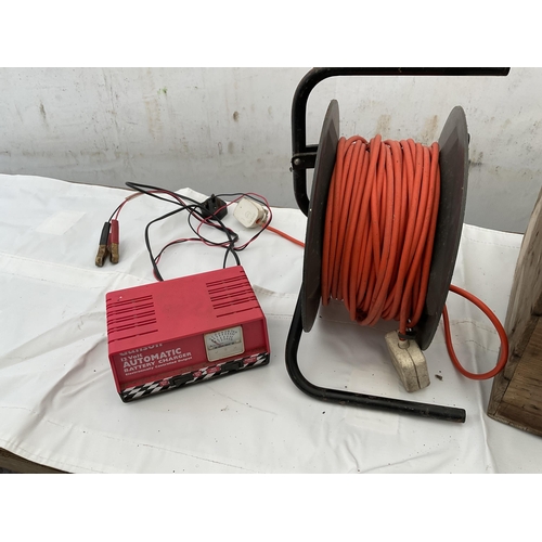 62 - WOODEN BOX ELECTRIC EXTENSION LEAD ON REEL  AND BATTERY CHARGER W/O