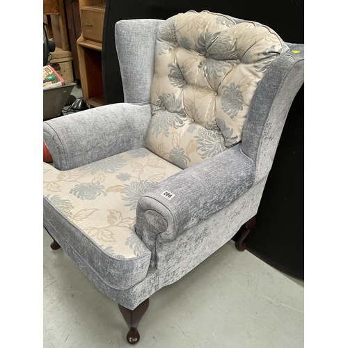 286 - BLUE PATTERNED UPHOLSTERED FIRESIDE CHAIR ON CABRIOLE LEGS