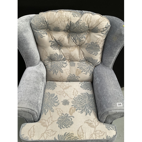 286 - BLUE PATTERNED UPHOLSTERED FIRESIDE CHAIR ON CABRIOLE LEGS