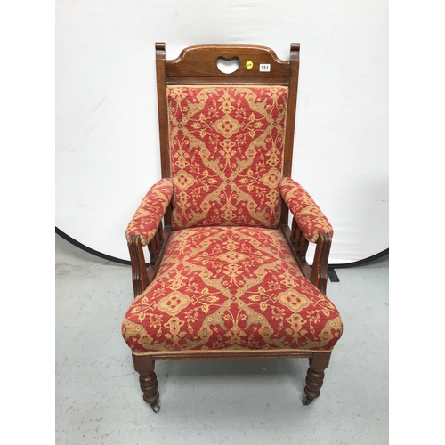 351 - EDWARDIAN OAK UPHOLSTERED ARMCHAIR ON TURNED LEGS AND ORIGINAL CASTORS