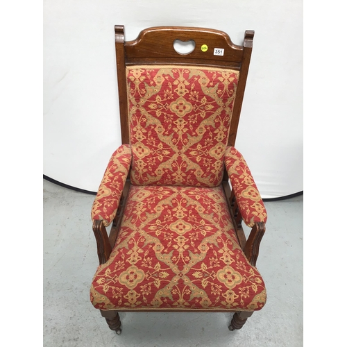 351 - EDWARDIAN OAK UPHOLSTERED ARMCHAIR ON TURNED LEGS AND ORIGINAL CASTORS