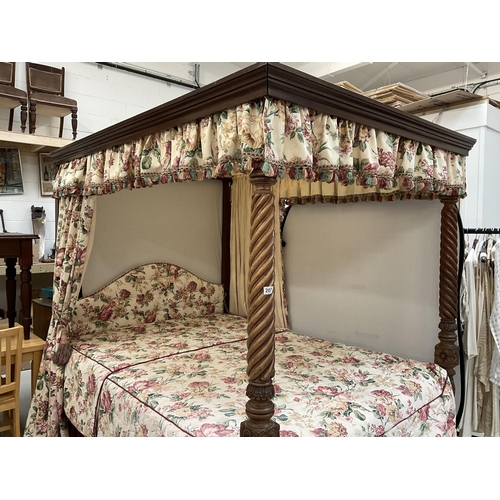 222 - MAHOGANY HEAVILY CARVED FOUR POSTER BED C/W SPIRAL DESIGN FLY AWAY  MAHOGANY CORNICE FLORAL UPHOLSTE... 