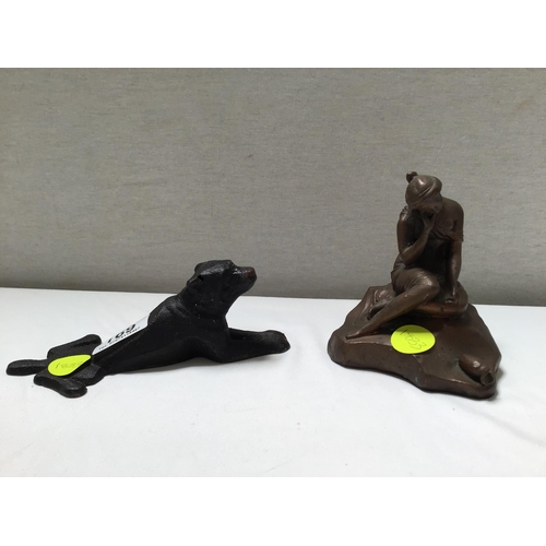 169 - METAL DOG DOOR STOP AND A SEATED LADY FIGURE