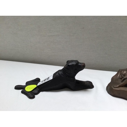 169 - METAL DOG DOOR STOP AND A SEATED LADY FIGURE