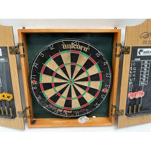 35 - DART BOARD IN CABINET 20.5 X 25