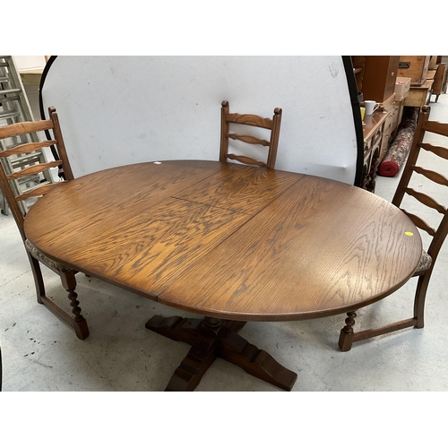 379 - BADGED OLD CHARM CARVED PEDESTAL CIRCULAR EXTENDING DINING TABLE AND 4 MATCHING RAILBACK CHAIRS ON T... 