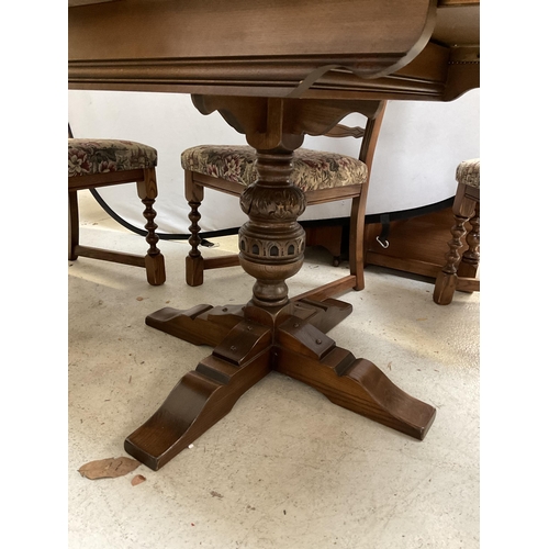 379 - BADGED OLD CHARM CARVED PEDESTAL CIRCULAR EXTENDING DINING TABLE AND 4 MATCHING RAILBACK CHAIRS ON T... 