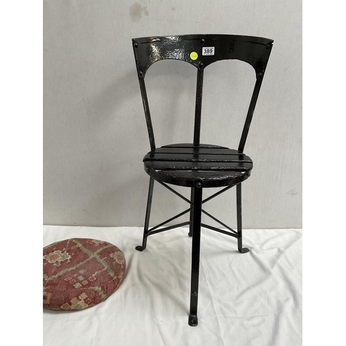 389 - CAST IRON STRETCHERED GARDEN SEAT WITH CUSHION