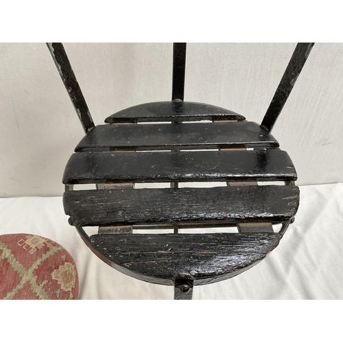 389 - CAST IRON STRETCHERED GARDEN SEAT WITH CUSHION