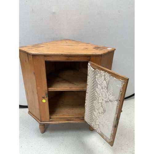 398 - STRIPPED PINE CORNER CABINET WITH SINGLE GLASS DOOR ON TURNED FEET - H32