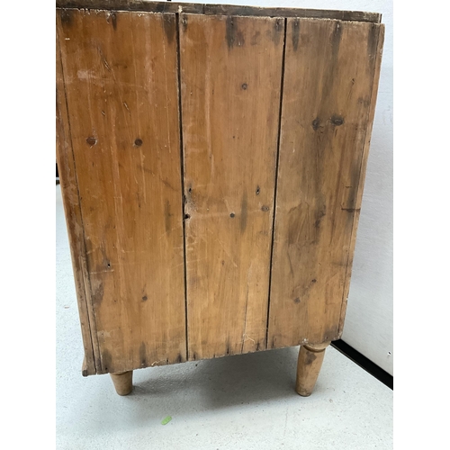 398 - STRIPPED PINE CORNER CABINET WITH SINGLE GLASS DOOR ON TURNED FEET - H32