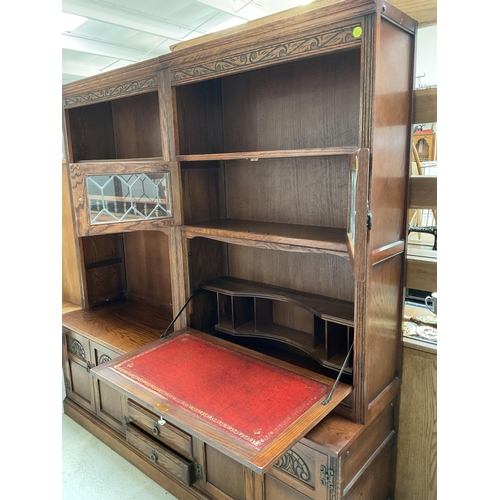 416 - BADGED OLD CHARM LOUNGE UNIT TOP WITH OPEN SHELVES 2 GLASS LEADED DOORS WITH DROP DOWN BUREAU WITH L... 